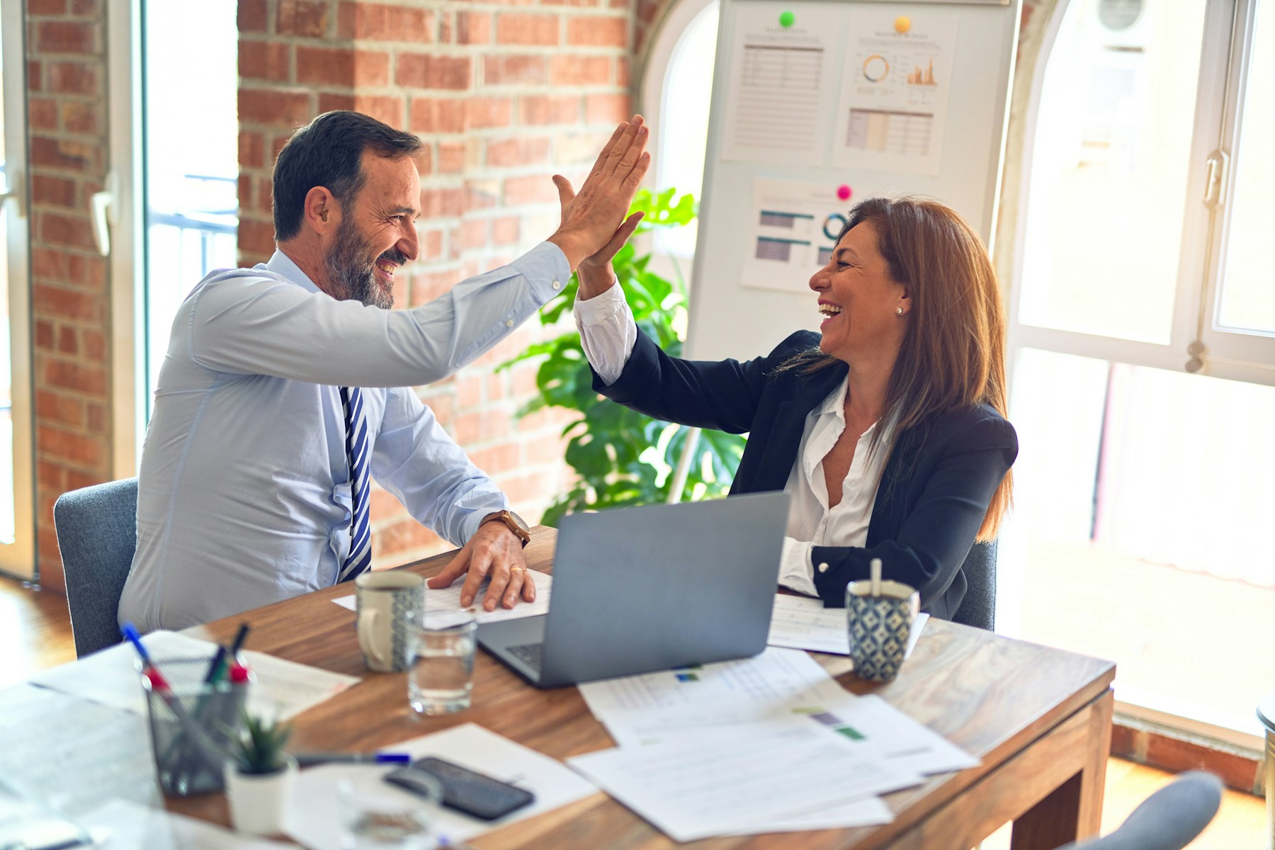 Illustrative business photograph of professionals working together in an office